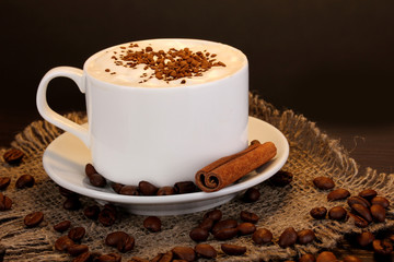 Latte on wooden table on brown background