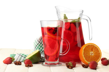 sangria in jar and glass with fruits,