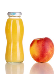 Delicious peach juice in glass bottle and peach next to it
