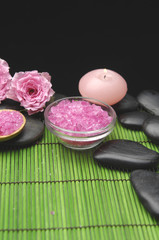 salt in bowl with rose and stones with candle on green mat