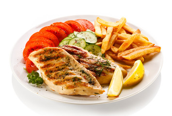 Grilled steaks, French fries and vegetables