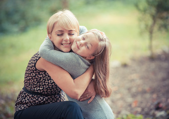 Fototapeta premium beautiful young mother and her daughter in the park