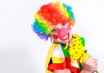Clown looking to the copy space area in a white studio