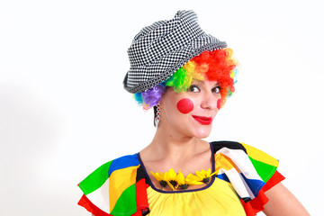 Clown looking to the copy space area in a white studio