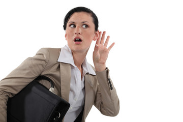 Businesswoman listening in shock