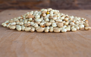 Hill of beans on the wooden table