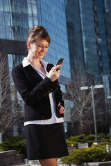 Portrait of a cute business woman over business center on back