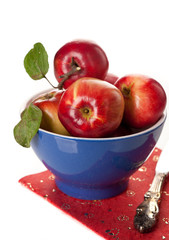 Red apples in a bowl on a white background