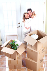Happy couple moving in a new house.
