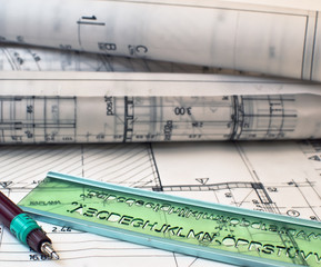 heap of design and project drawings on table background