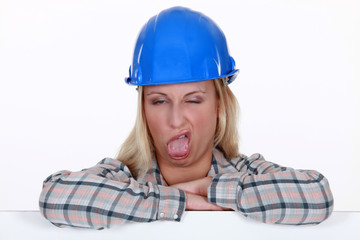 Female construction worker pulling a silly face