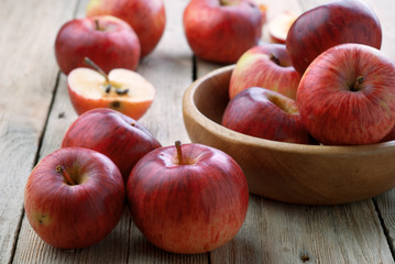 A bowl of red apples on the wooden table