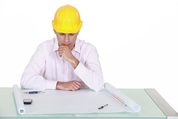 Architect studying plans carefully