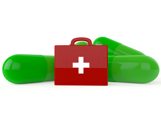Red first aid kit with green capsules