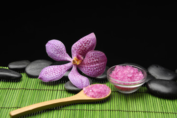 Fototapeta na wymiar pink orchid with zen stone and sea salt in spoon on mat