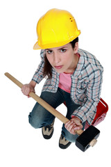 female builder holding a sledge hammer