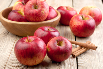 Red apples in a wooden bowl on the table