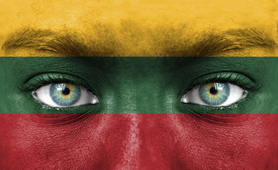 Human face painted with flag of Lithuania