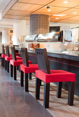 Red chairs near bar in sushi restaurant, indoor