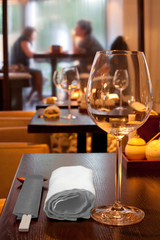 table with glasses sticks in sushi bar, couple sitting by window