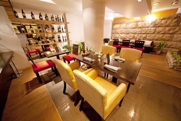 Hall with leather chairs near bar in sushi restaurant