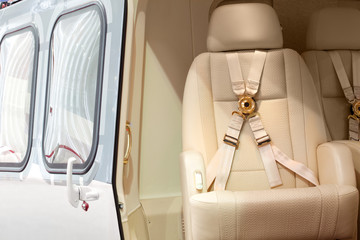 Helicopter business class interior with chairs seat belts