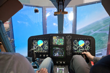 Two guys  flying on helicopter simulator