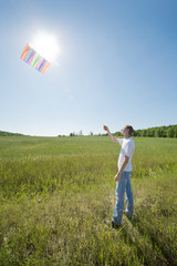 young man launch kite in field