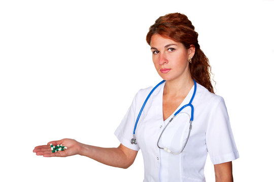 Doctor giving or showing pills or capsules on stretched hand