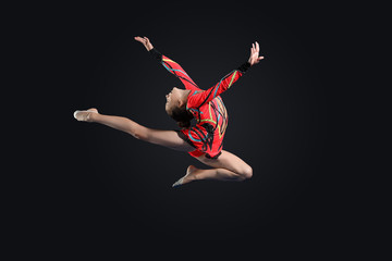 Fototapeta premium Young woman in gymnast suit posing