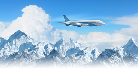 Fototapeta premium White passenger plane above the mountains