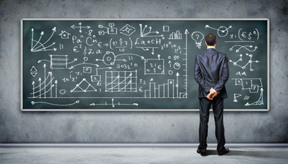 Business person against the blackboard