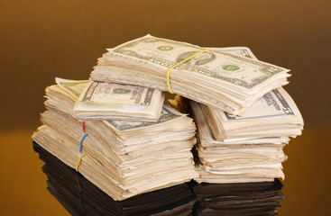 Stacks of dollars on orange background
