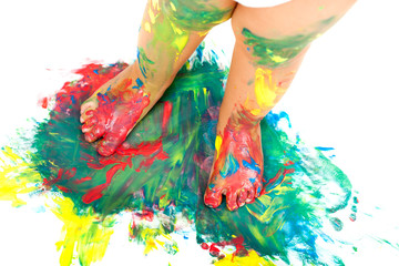 Babies feet on colorful mosaic paint.