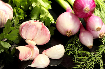 young garlic peeled and onion with greenery