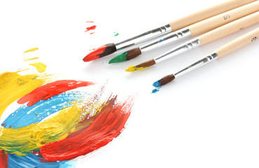 Obraz premium Abstract gouache paint and brushes, isolated on white