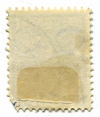 The reverse side of a postage stamp.