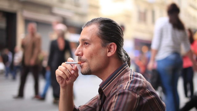 depresed man smoking on the street