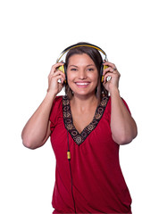 Woman holds headphones to her ears.