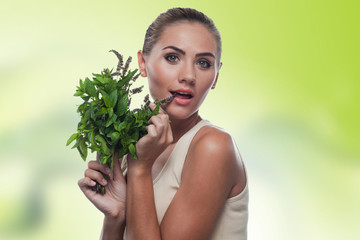young woman with with a bundle of fresh mint