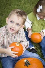 Cute Young Brother and Sister At the Pumpkin Patch
