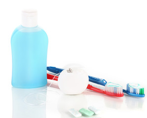 Toothbrush, chewing gum and dental floss isolated on white