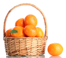 tangerines with leaves in a beautiful basket isolated on white