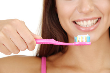Beautiful young woman with toothbrush close-up