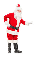 Full length portrait of a happy Santa Claus gesturing