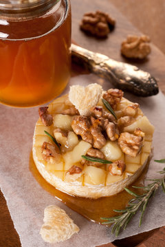 Baked Camembert  with toasted bread, rosemary and nuts