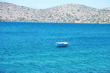 Blue and white wooden boat at a Mediterranean sea (Greece)