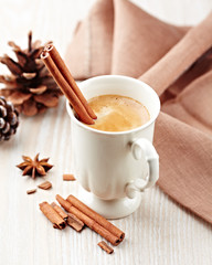 Mug of coffee with cinnamon and anise