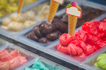 Variety of yummy ice creams under shopping window