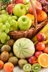 Composition with assorted fruits in wicker basket